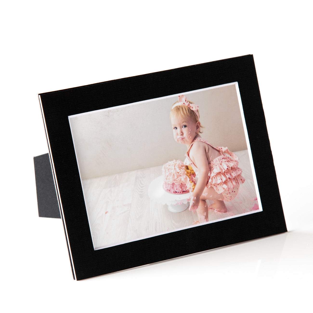 Each mount has its own built in stand on the back. Simply fold it out, click it in to place, and stand it up in a vertical OR horizontal position. Prints easily slide through a space at the side of the mount.