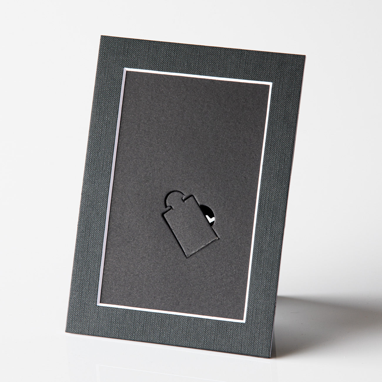 Each mount has its own built in stand on the back. Simply fold it out, click it in to place, and stand it up in a vertical OR horizontal position. Prints easily slide through a space at the side of the mount.