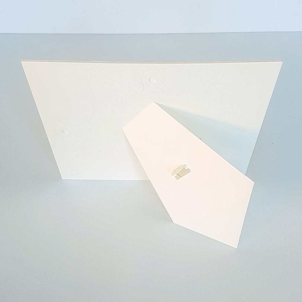 Each mount has its own built in stand on the back. Simply fold it out, click it in to place, and stand it up in a vertical OR horizontal position. Prints easily slide through a space at the side of the mount.