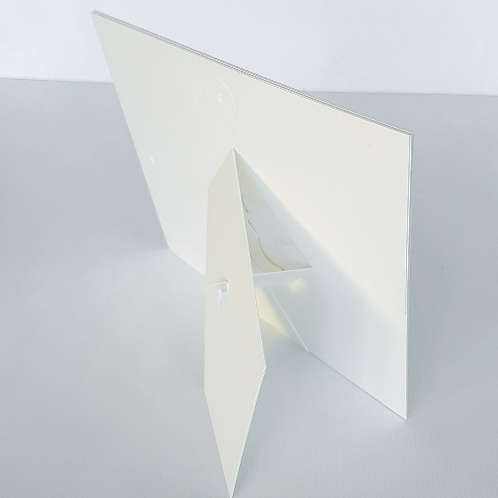 Each mount has its own built in stand on the back. Simply fold it out, click it in to place, and stand it up in a vertical OR horizontal position. Prints easily slide through a space at the side of the mount.