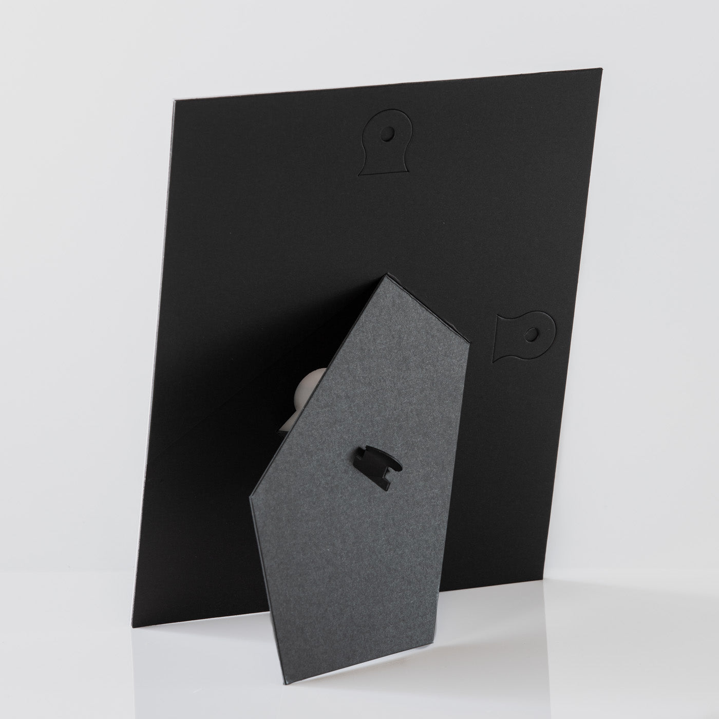 Each mount has its own built in stand on the back. Simply fold it out, click it in to place, and stand it up in a vertical OR horizontal position. Prints easily slide through a space at the side of the mount.