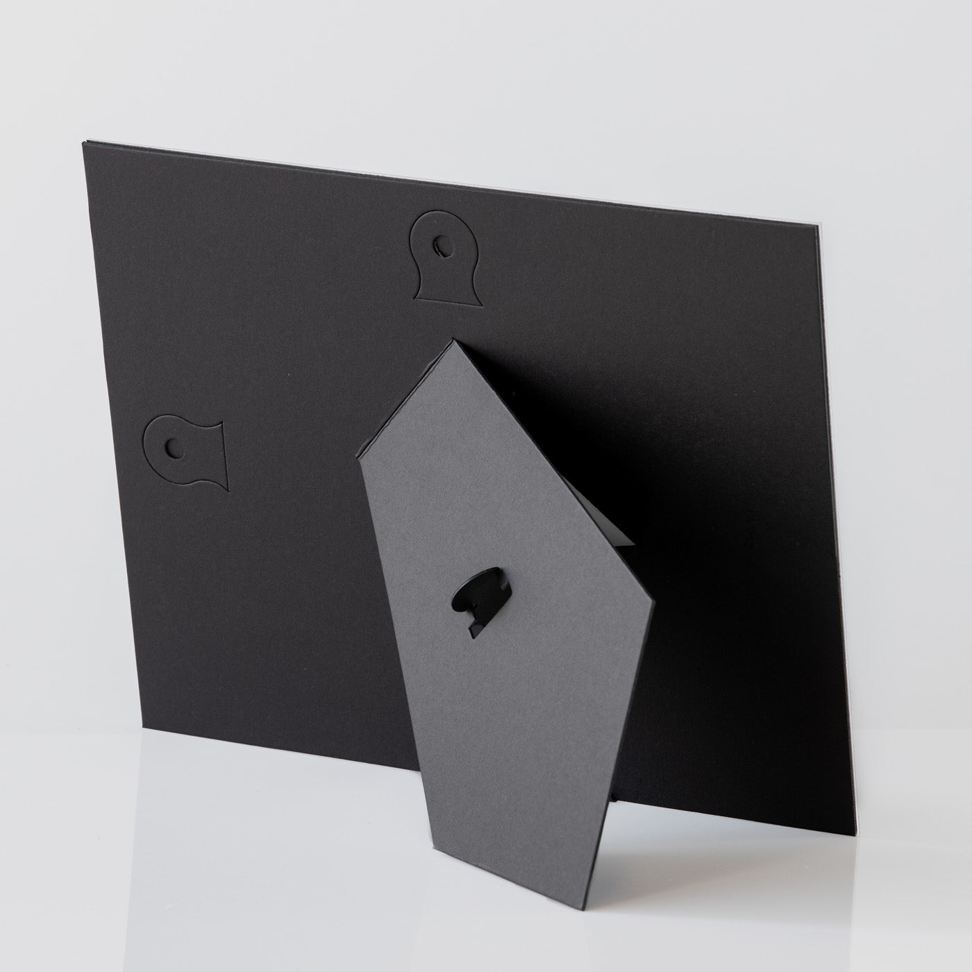 Each mount has its own built in stand on the back. Simply fold it out, click it in to place, and stand it up in a vertical OR horizontal position. Prints easily slide through a space at the side of the mount.