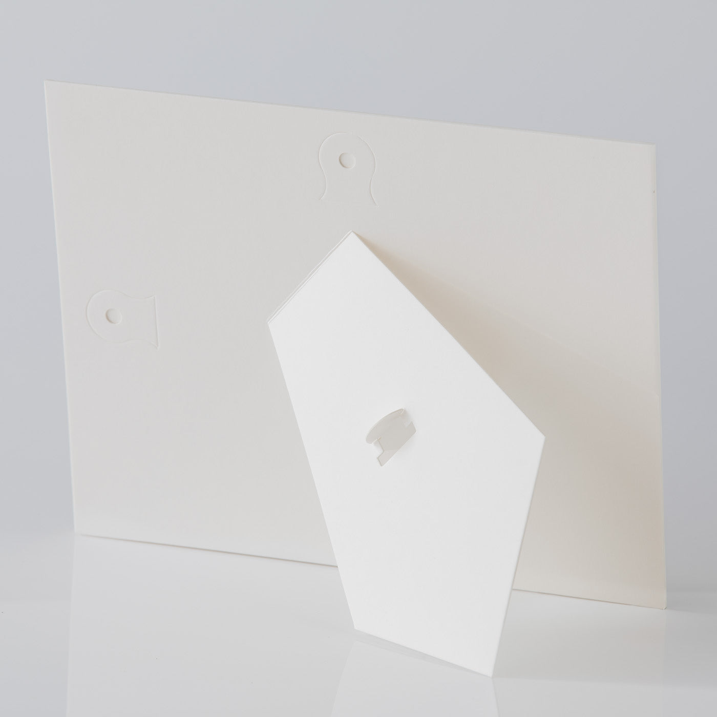 Each mount has its own built in stand on the back. Simply fold it out, click it in to place, and stand it up in a vertical OR horizontal position. Prints easily slide through a space at the side of the mount.