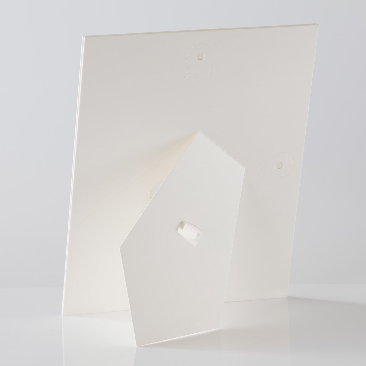 Each mount has its own built in stand on the back. Simply fold it out, click it in to place, and stand it up in a vertical OR horizontal position. Prints easily slide through a space at the side of the mount.