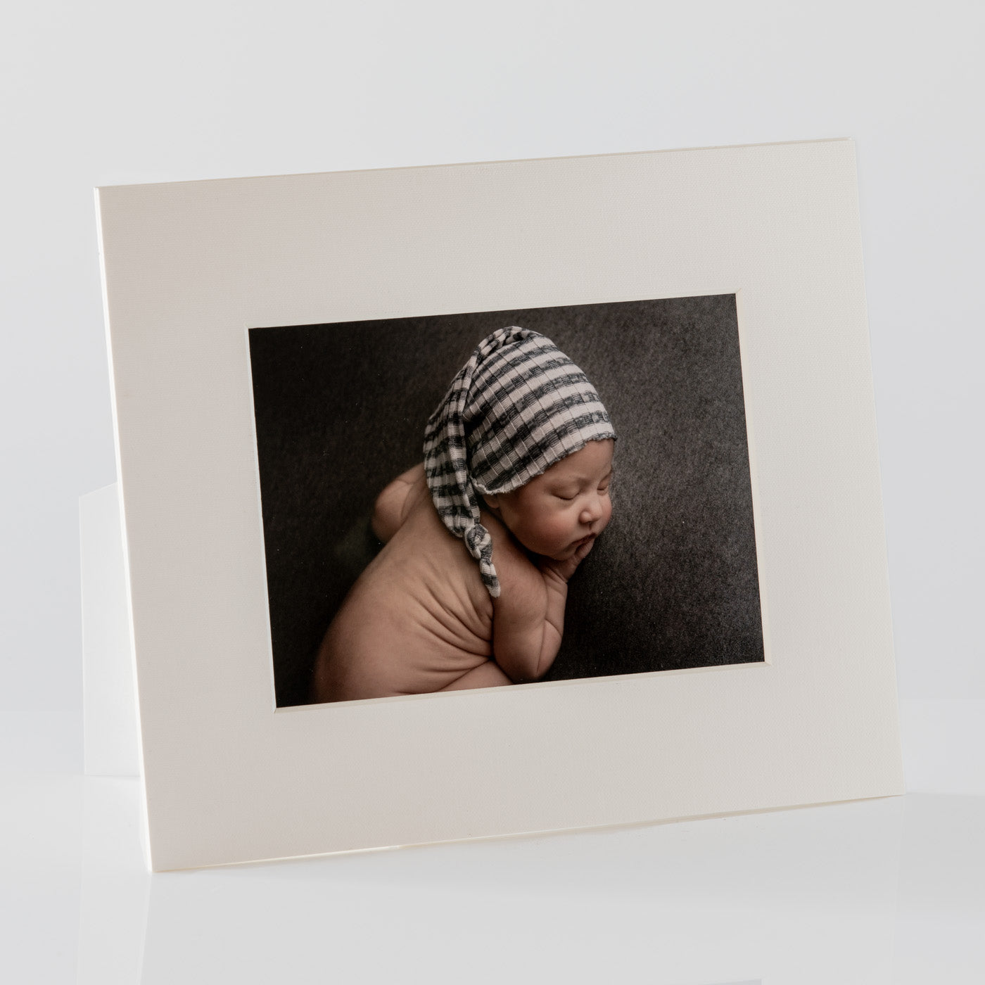 Each mount has its own built in stand on the back. Simply fold it out, click it in to place, and stand it up in a vertical OR horizontal position. Prints easily slide through a space at the side of the mount.