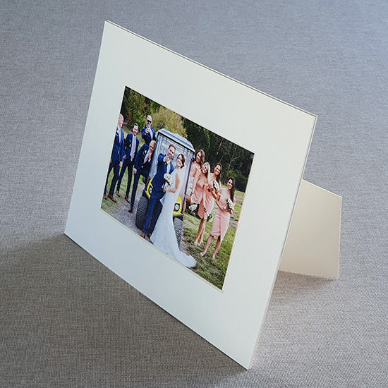 Each mount has its own built in stand on the back. &nbsp;Simply fold it out, click it in to place, and stand it up in a vertical OR horizontal position. &nbsp;Prints easily slide through a space at the side of the mount.