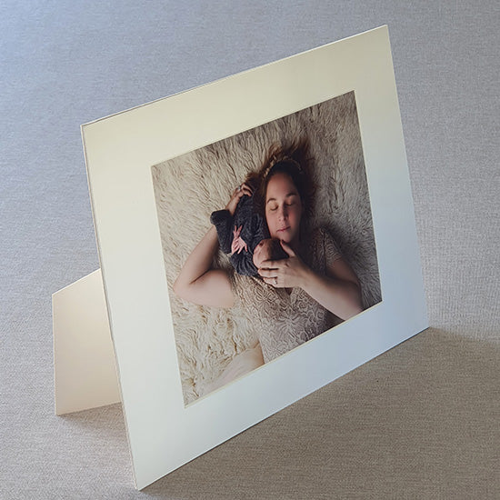 Each mount has its own built in stand on the back. Simply fold it out, click it in to place, and stand it up in a vertical OR horizontal position. Prints easily slide through a space at the side of the mount.