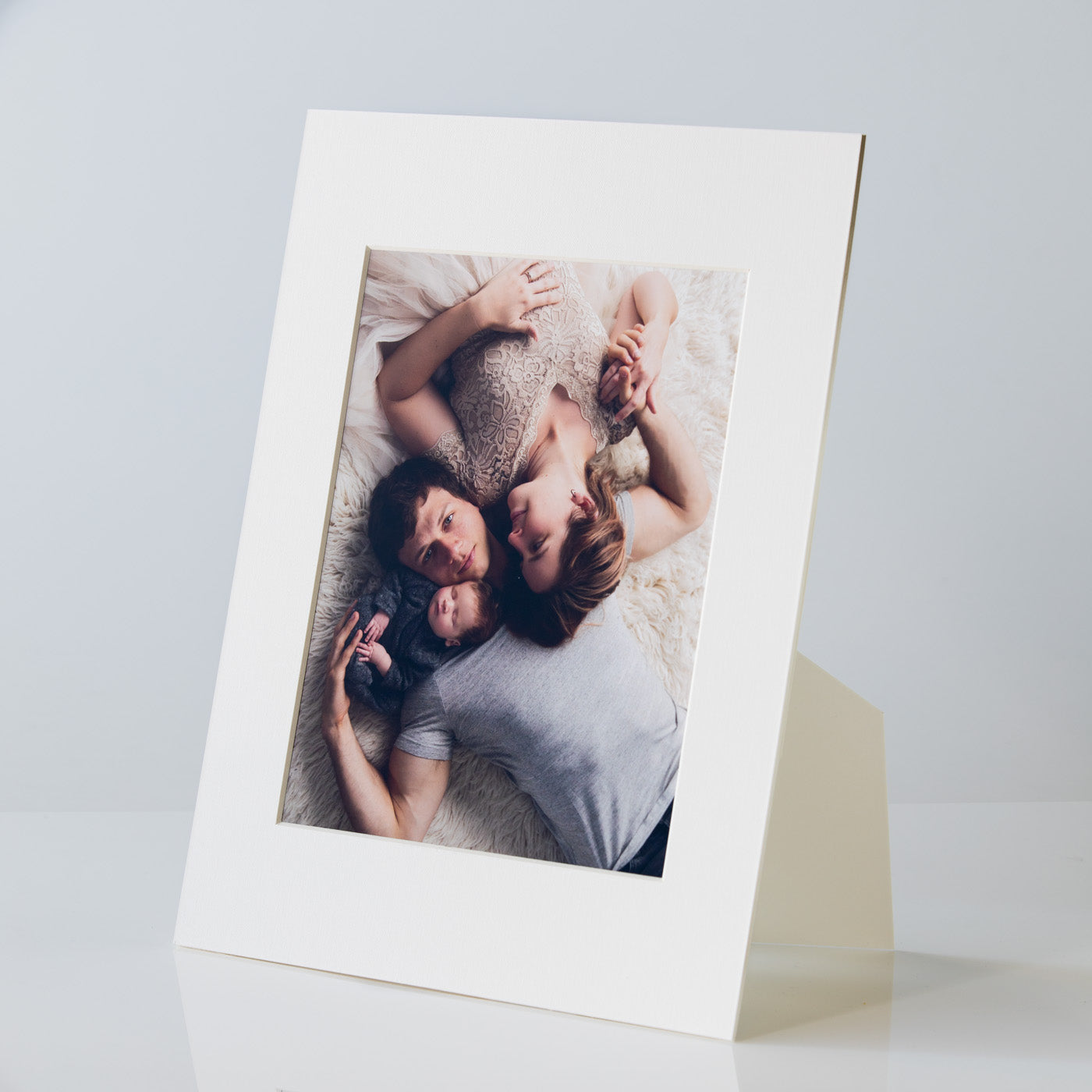 Each mount has its own built in stand on the back. Simply fold it out, click it in to place, and stand it up in a vertical OR horizontal position. Prints easily slide through a space at the side of the mount.