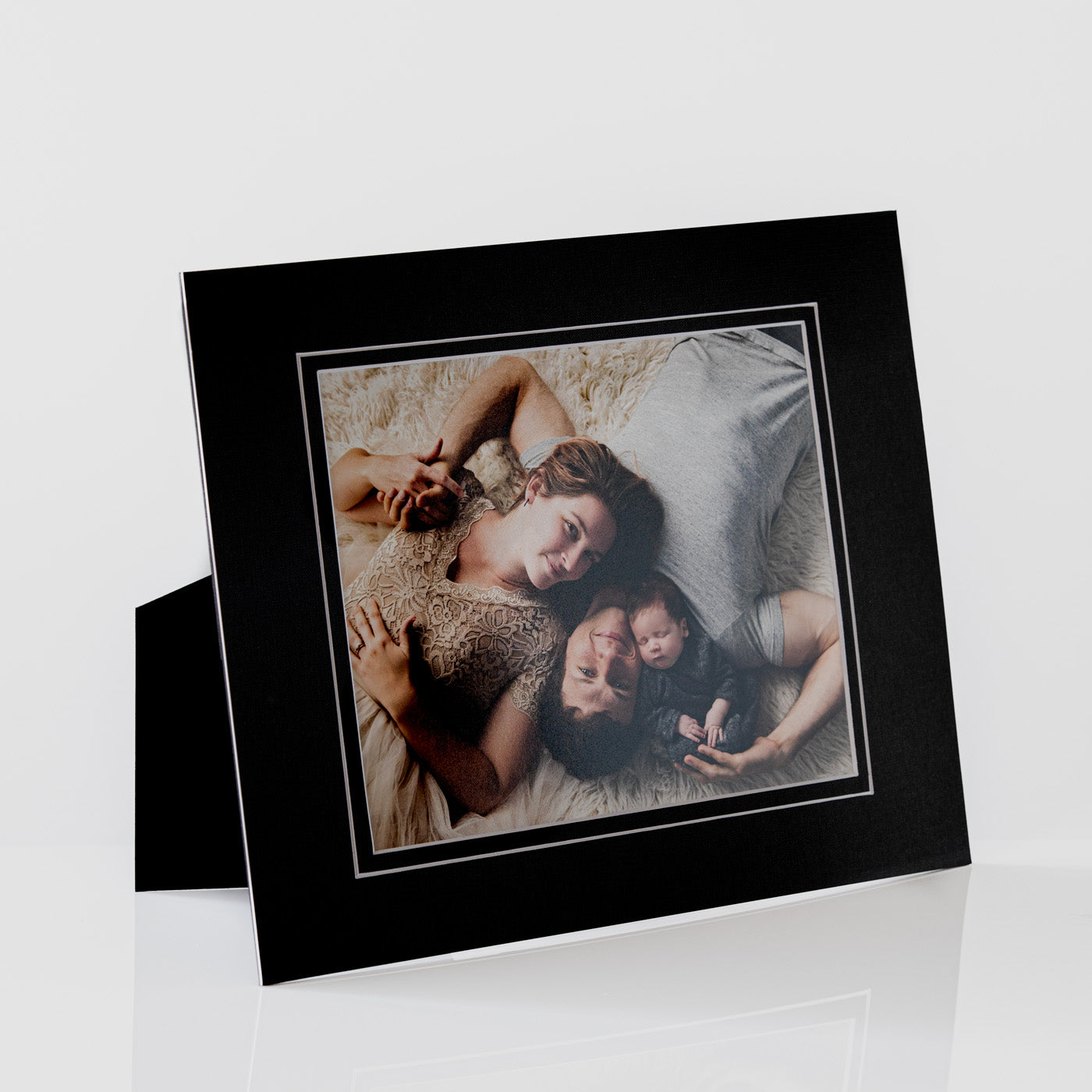 Each mount has its own built in stand on the back. Simply fold it out, click it in to place, and stand it up in a vertical OR horizontal position. Prints easily slide through a space at the side of the mount.