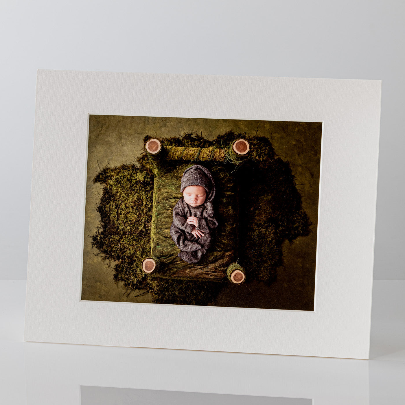 Each mount has its own built in stand on the back. Simply fold it out, click it in to place, and stand it up in a vertical OR horizontal position. Prints easily slide through a space at the side of the mount.