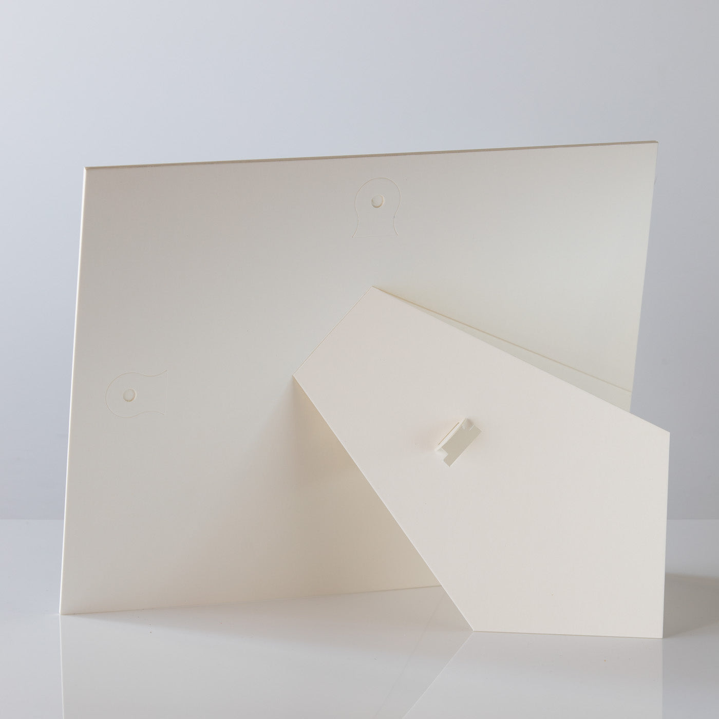 Each mount has its own built in stand on the back. Simply fold it out, click it in to place, and stand it up in a vertical OR horizontal position. Prints easily slide through a space at the side of the mount.