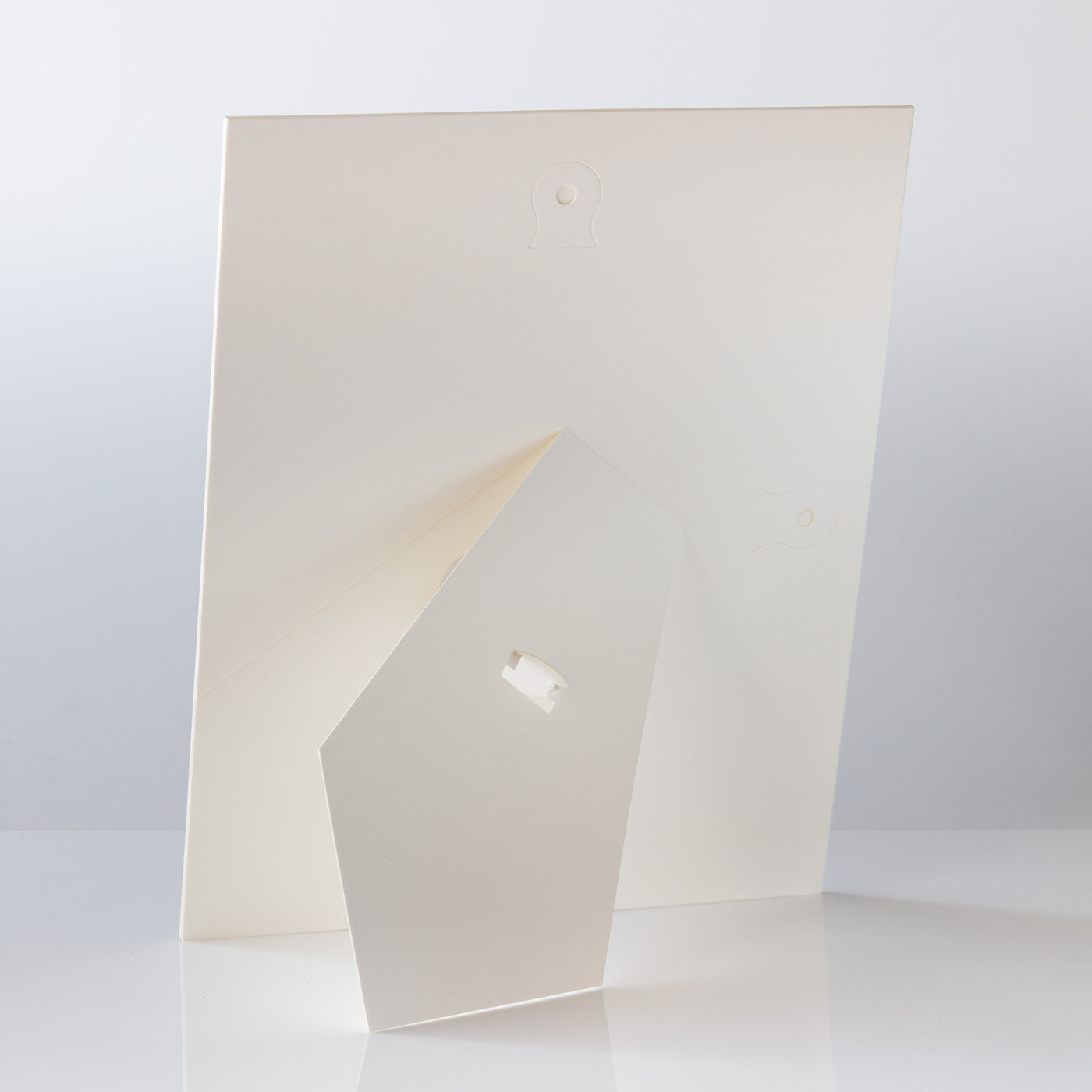 Each mount has its own built in stand on the back. Simply fold it out, click it in to place, and stand it up in a vertical OR horizontal position. Prints easily slide through a space at the side of the mount.