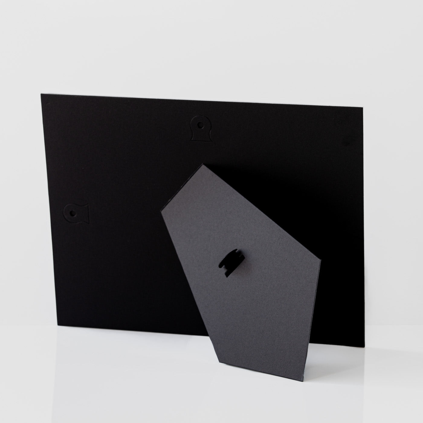 Each mount has its own built in stand on the back. Simply fold it out, click it in to place, and stand it up in a vertical OR horizontal position. Prints easily slide through a space at the side of the mount.